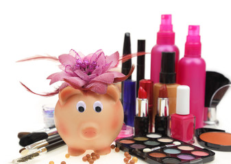 Piggy bank with various cosmetics isolated on white background