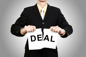 Businessman tear paper with word Deal