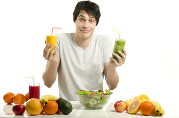 Obraz premium Happy man holding organic smoothie, fruits, salad,healthy food
