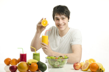 Obraz premium Happy man holding organic smoothie, fruits, salad,healthy food
