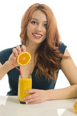 Happy woman preparing orange organic smoothie,squeazing orange