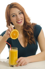Happy woman preparing orange organic smoothie,squeazing orange