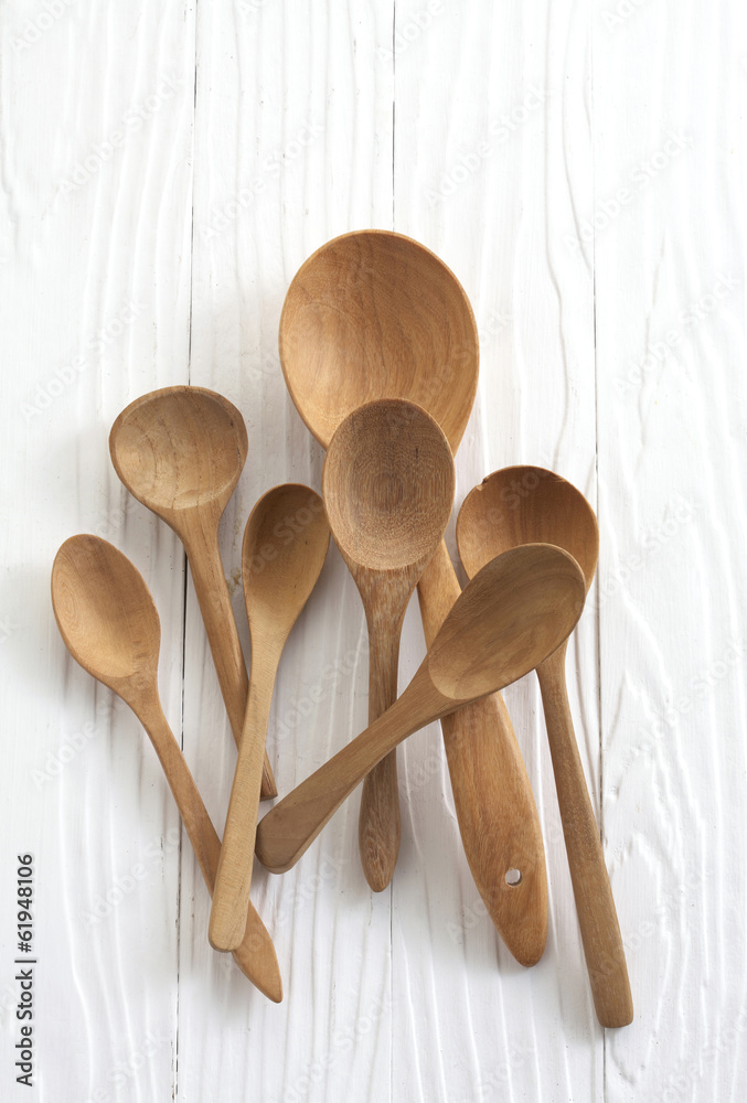 Wall mural wooden spoons on white background