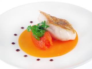 fried fish on pumpkin sauce