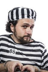 Desperate, portrait of a man prisoner in prison garb, over white