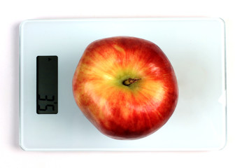 Red apple on scales