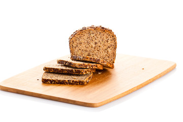 Loaf of wholemeal bread  cutting into slices on wood bread board