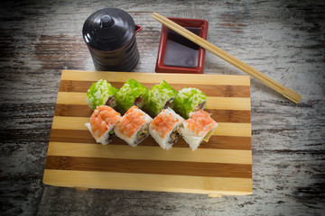 Fototapeta na wymiar Sushi roll on a vintage background