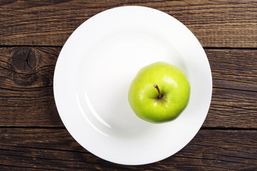 Green apple on a plate