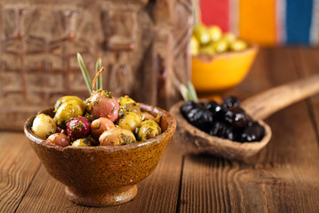 marinated Olives in bowls with moroccan  ornament on wood