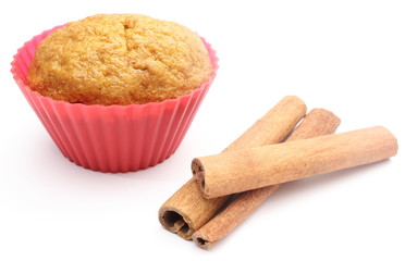 Fresh baked carrot muffin and cinnamon stick. White background