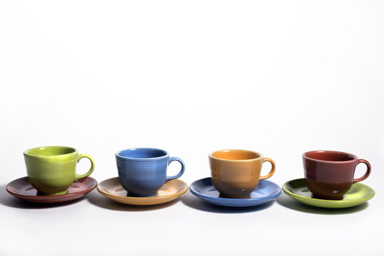 Row of colorful cups and saucers