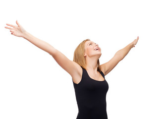 Fototapeta premium smiling girl in blank black tank top waving hands