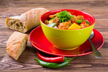 Delicious goulash on wooden table