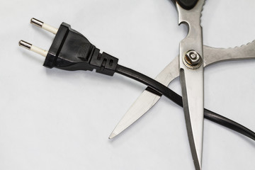 scissors cutting electric plug