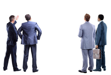 four business mans from the back - looking at something