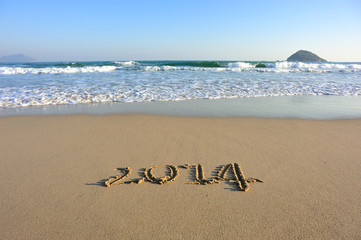 2014 word drawn on beach