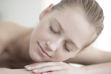Obraz na płótnie Canvas closeup of a beautiful young woman lying on a massage table
