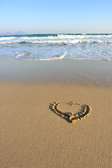 heart shape word drawn on beach
