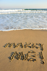 marry me word drawn on beach