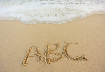 abc word drawn on beach