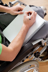 Disabled man holding a notebook
