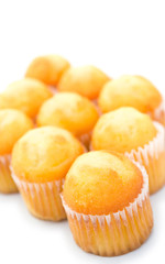 golden cup cakes on a white background
