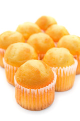 golden cup cakes on a white background
