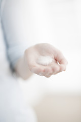white feather on a woman hand closeup