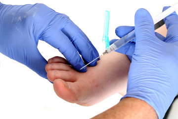 close up of a doctor giving a shot in the foot © sixdays