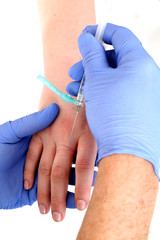 close up of a doctor giving a shot in the hand
