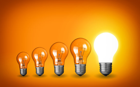 Row of light bulbs.Idea concept on orange background.