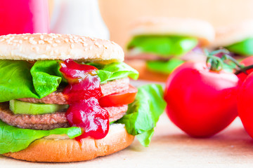 Appetizing big cheeseburger fresh lettuce cucumber