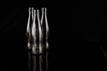 Empty bottles over black background