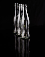 Empty bottles over black background