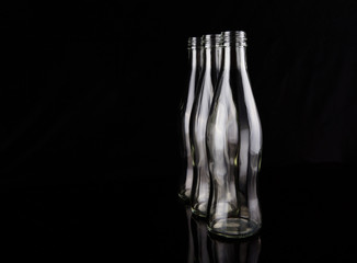 Empty bottles over black background
