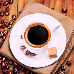 Coffee cup and roasted coffee beans  on wooden  brown background