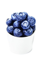 Fresh bilberries in a bowl  isolated on white background macro.