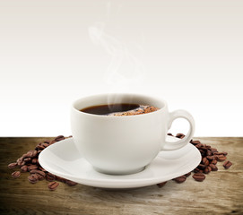 Coffee cup and saucer on a wooden table (clipping path).