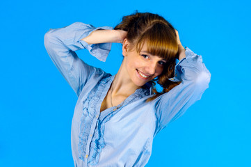 pretty girl posing in studio on a blue background