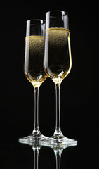 Glasses of champagne, on black background