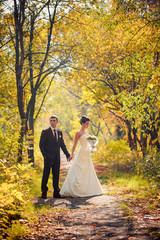 bride and groom walk in nature