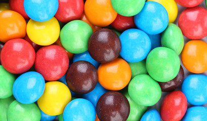 Background of chocolate balls in colorful glaze.