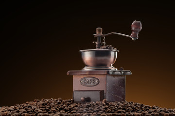 Retro manual coffee mill on roasted coffee beans