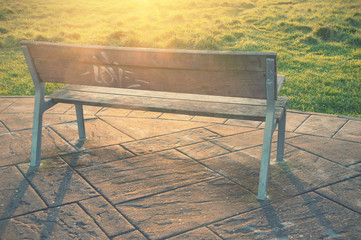 wooden bench with sun rays and vintage effect