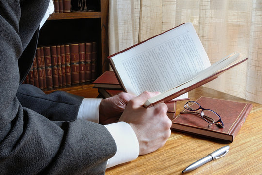 man reading a book with interest