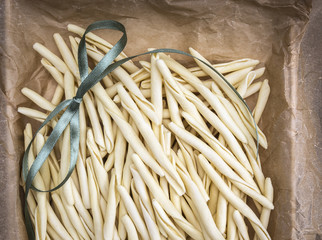 homemade noodles, fileja, with green bow in wrinkled paper