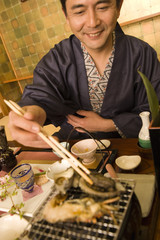 male in yukata having meal