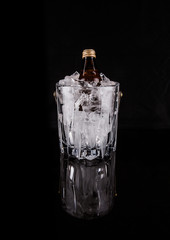 A bottle of refreshing drink chilled in an ice bucket