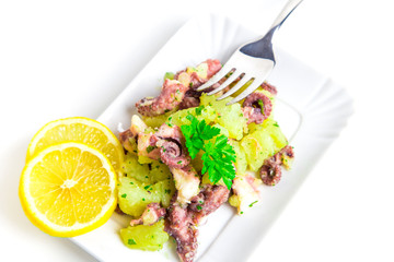 Octopus salad with lemon slice and potatoes with parsley